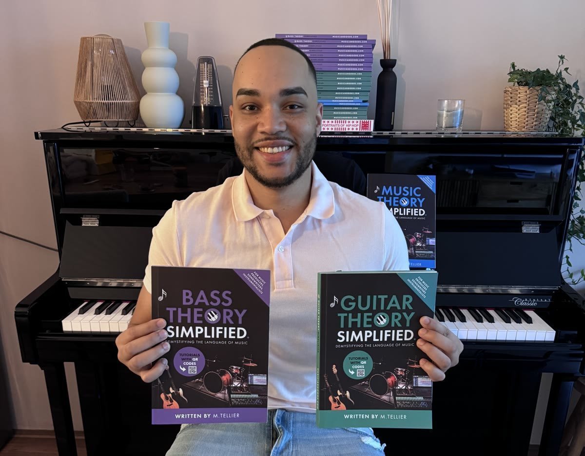 Melvin Tellier, founder of Musiciangoods, holding his theory books